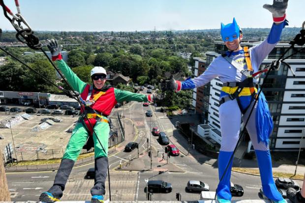 A photo of Batman and Robin abseiling